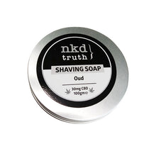 Load image into Gallery viewer, A round metallic tin featuring a black and white label on the lid. The label displays "nkd truth" at the top, "SHAVING SOAP" centrally, and "Oud fragrance" beneath it. At the bottom, it notes "30mg CBD 100gme." This men’s grooming essential is likely NKD's 30mg CBD Speciality Shaving Soap with an Oud scent.