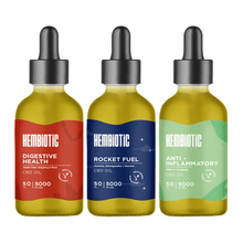 Load image into Gallery viewer, Three dropper bottles of Hembiotic 5000mg Bulk CBD Oil - 50ml are aligned side by side. The first bottle is labeled "Digestive Health" with a red design. The second, "Rocket Fuel," showcases a blue design. The third, "Anti-Inflammatory," features a green design. Each vegan-friendly bottle contains lab-tested CBD oil from the Hembiotic brand.