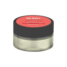 Load image into Gallery viewer, A small, cylindrical container with a black lid and a clear body holds a vegan-friendly, CBD-infused lip balm. The label on the lid is red and reads "Sensi Skin 100mg CBD Lip Balm - Strawberry." The net weight is listed as 25ml, and it comes with a BUY 1 GET 1 FREE offer.