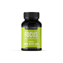 Load image into Gallery viewer, A black bottle labeled &quot;Vitacanna 500mg Broad Spectrum CBD Vegan Capsules - 50 Caps&quot; sits against a green background, featuring per-capsule highlights: 10mg broad spectrum CBD, 10mg iron, and 200mg Rhodiola Rosea from organic hemp. Brand: Vitacanna.
